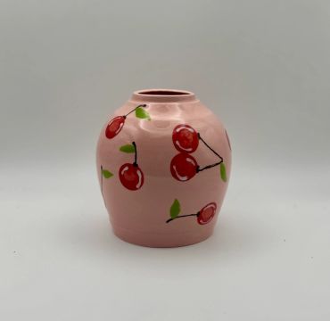 Pink ceramic vase with cherry design.