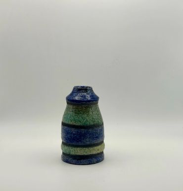 Small ceramic vase with blue and green stripes.
