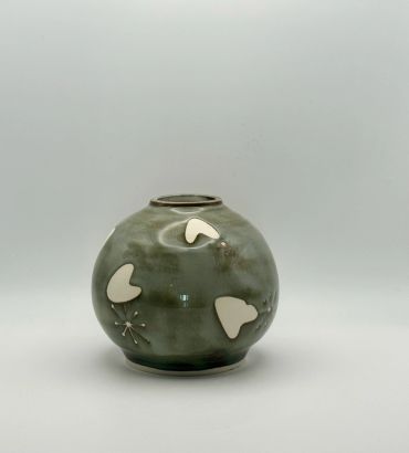 Round ceramic vase with white heart designs.