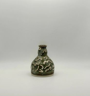 Small decorative green vase with white abstract designs.