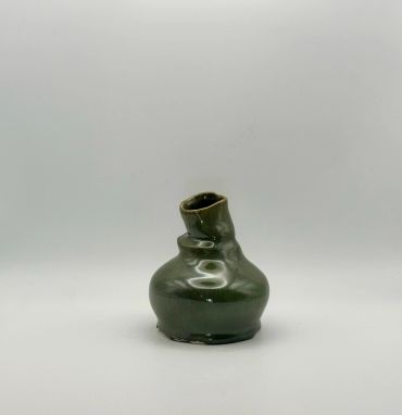 Small green ceramic vase with a tilted neck.