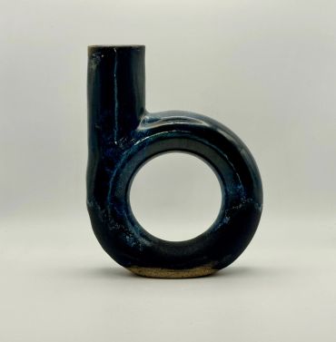 Black ceramic vase with a circular base and a vertical spout.