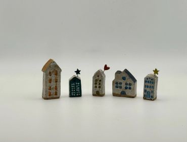 Miniature ceramic houses with star and heart decorations.