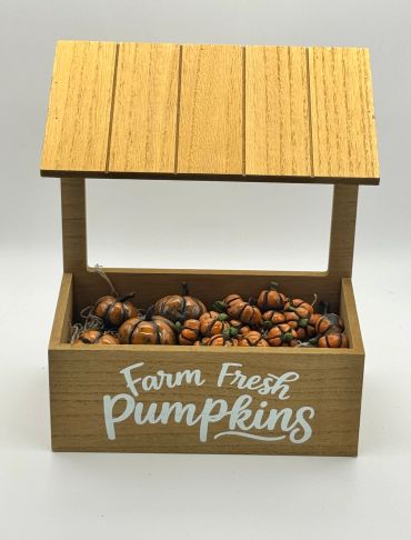Wooden crate with tiny decorative pumpkins.