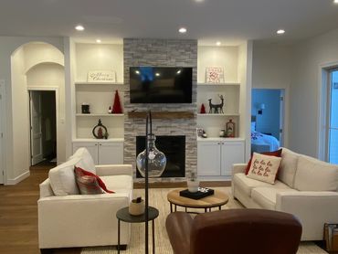 Cozy living room with beige sofas and modern fireplace.