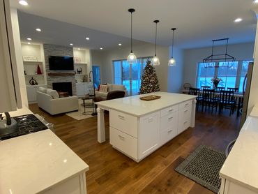 Spacious modern kitchen and cozy living area with Christmas decorations.