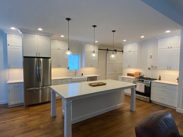 Modern kitchen with white cabinetry and island.
