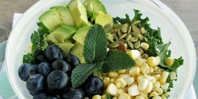 Kale Salad with Blueberry Avocado & Fresh Corn tossed in Dressing and topped with Toasted Pepitas 