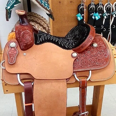 Intricate leather horse saddle on display.