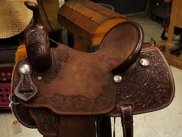 Intricately tooled leather horse saddle.