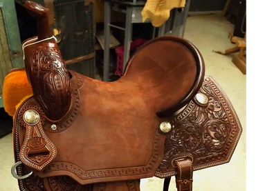 Detailed brown leather horse saddle.