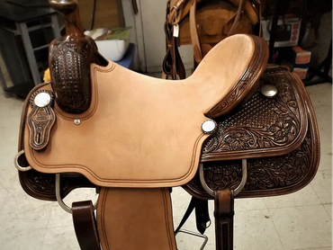Intricately tooled leather western saddle.