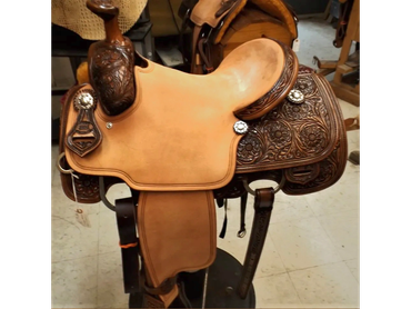 Detailed tooled leather Western saddle with floral patterns.