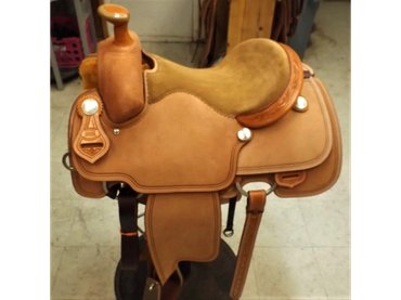 Light brown leather horse saddle with detailed stitching.