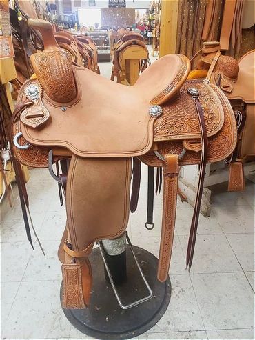 Intricately designed leather saddle on display.