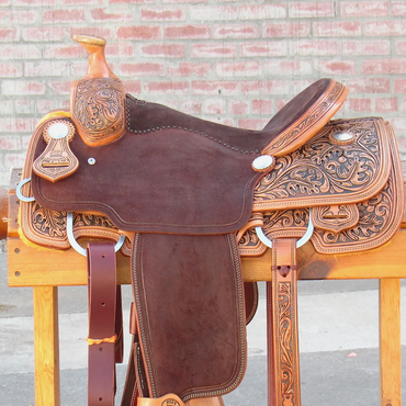 A detailed leather horse saddle on a wooden stand.