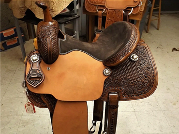 Intricately tooled leather Western horse saddle.