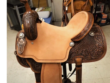 Beautifully crafted leather horse saddle with intricate designs.
