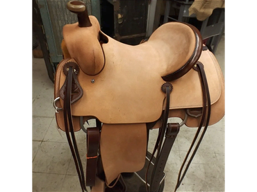 A light brown leather Western horse saddle.