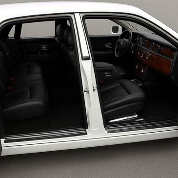 Luxury car interior with black leather seats and wood trim.