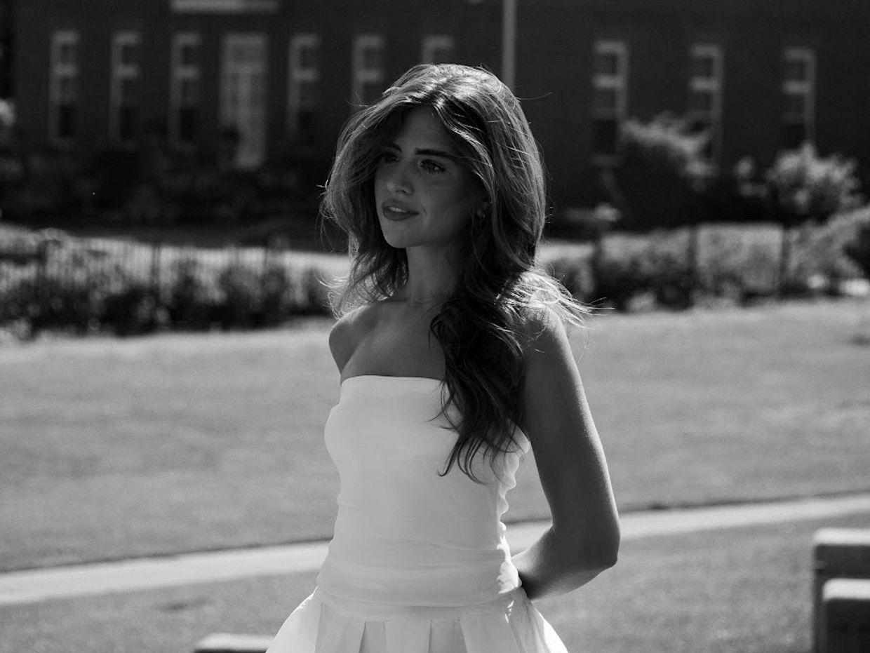 Woman in a strapless dress outdoors in black and white.