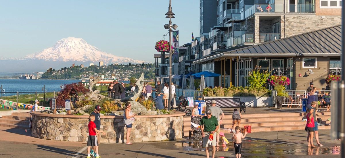 Point Ruston boardwalk with a view of Mt Rainer in the background and old town Tacoma on the hill.