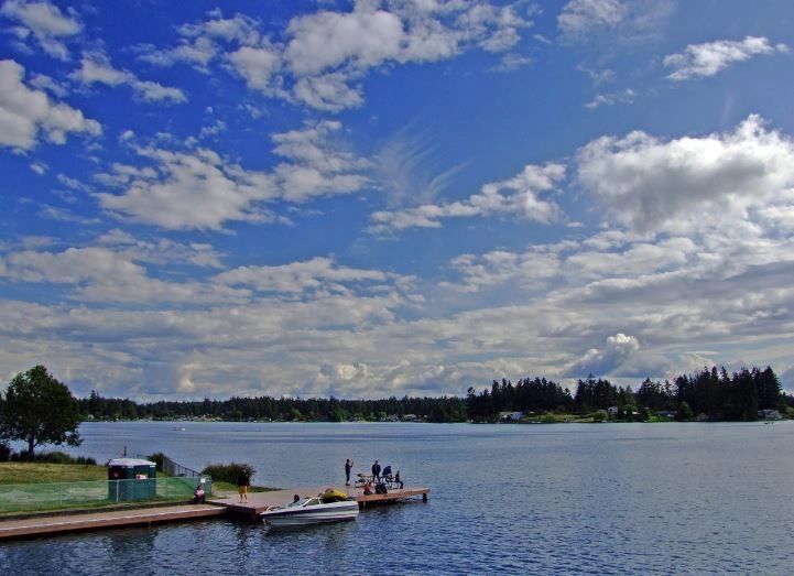An image of Spanaway Lake overlooking Dragon Isle by Parkland and Spanaway in Washington.