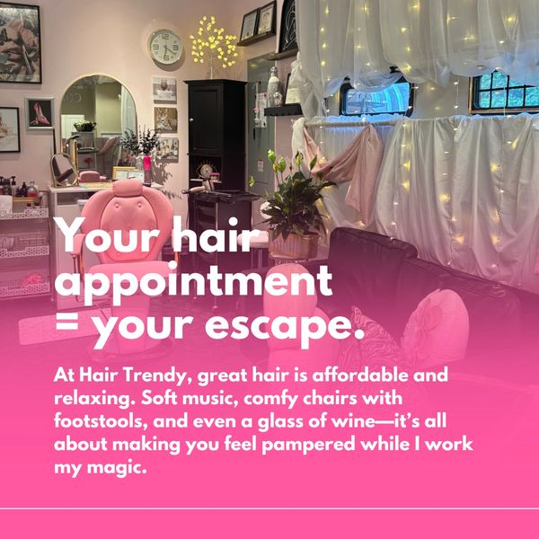 A cozy hair salon with comfy chairs, soft lighting, and a relaxing atmosphere.