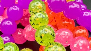 Brightly colored Steelhead soft beads displayed on top of each other.