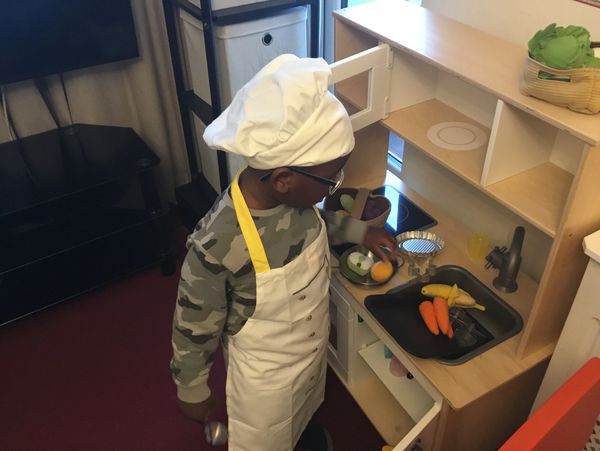 A little boy with a chef's ha