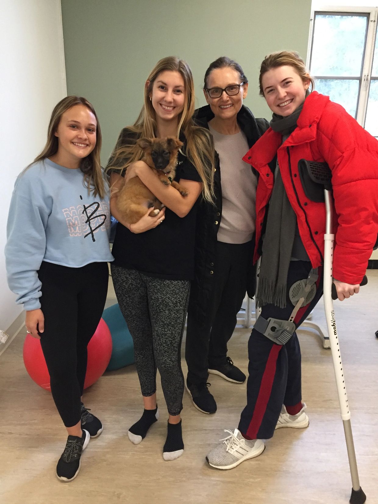 Four women with a dog