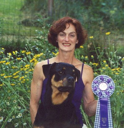 woman with Rottweiler and rosette