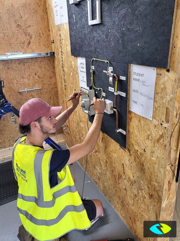 Student working on electrical wiring panel.