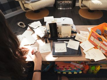 Person writing place cards