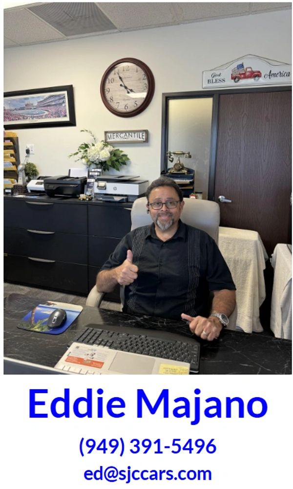 Man giving thumbs up at office desk with contact info below.