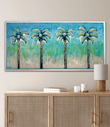 Painting of four palm trees with a blue-green background above a wooden cabinet.