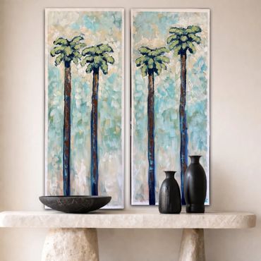 Two framed paintings of tall palm trees above a stone table with vases and a bowl.