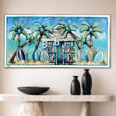 Colorful tropical painting with palm trees and surfboards above a console table.