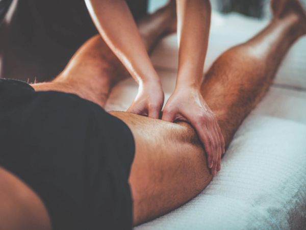 A person receiving a thigh massage.