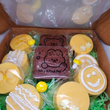 Assorted decorated yellow and brown cookies in a gift box.