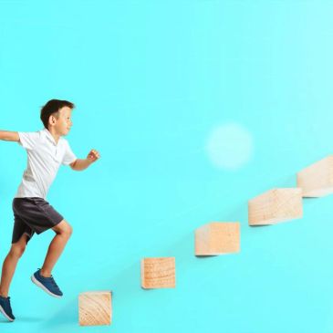 Boy jumping onto wooden steps.