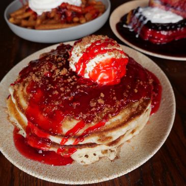 Strawberry Cheesecake Pancakes at Jackson House topped with mousse, strawberry crunch, and strawberry