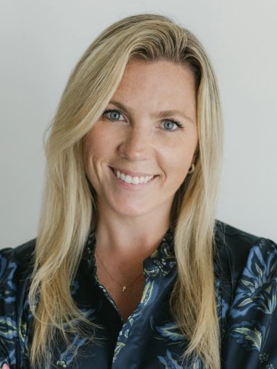 Smiling blonde woman with blue eyes.