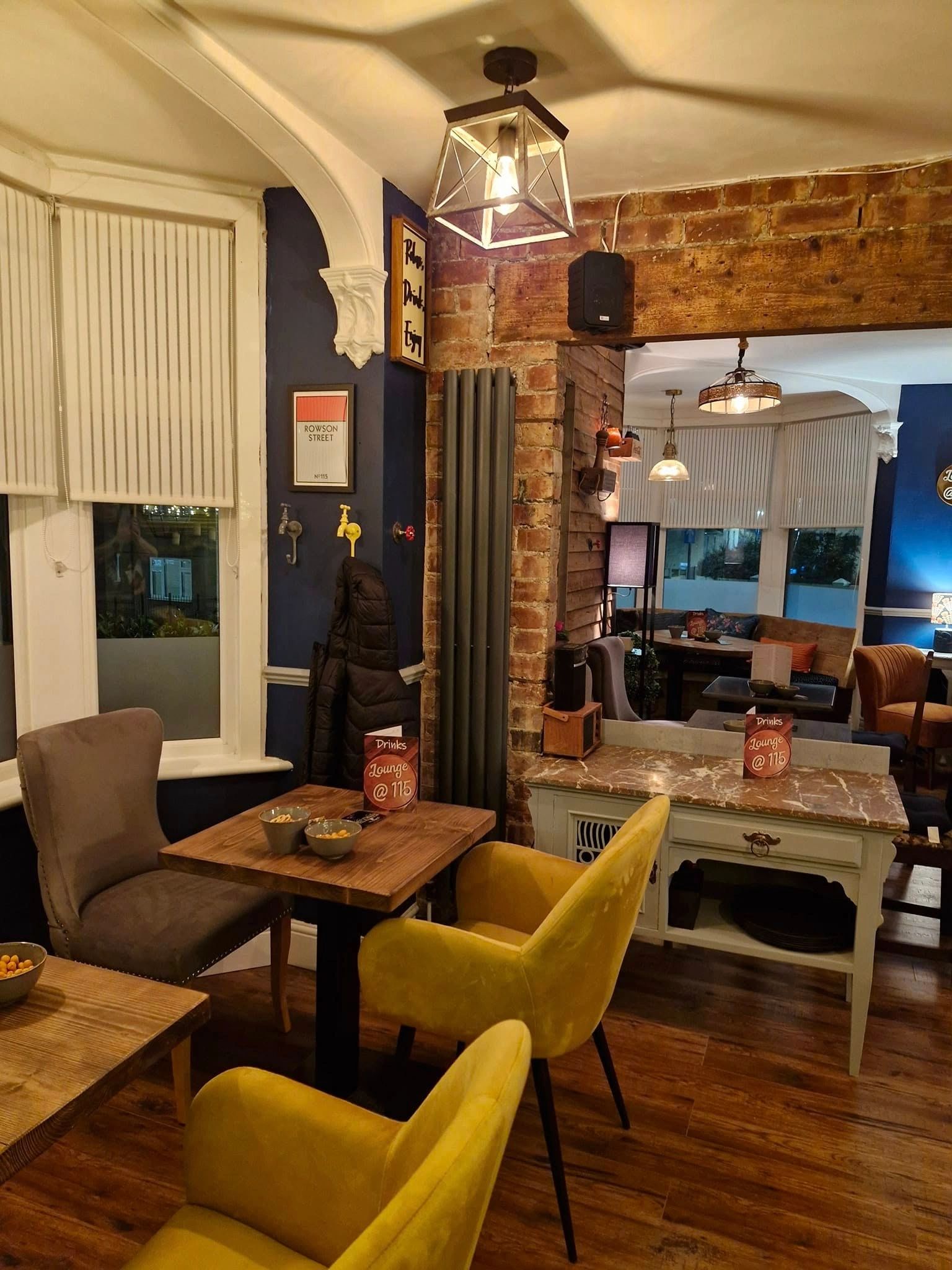 Cozy lounge area with yellow chairs and warm lighting.