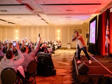 Performer engaging with an audience at a conference.