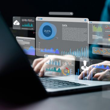 Person analyzing digital data charts on a laptop with futuristic interface.
