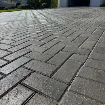 Freshly sealed brick paver driveway with enhanced color and protection
