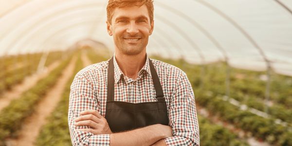 Man Standing in a greenhouse