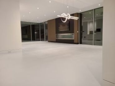Modern empty room with sleek lighting and glass walls.