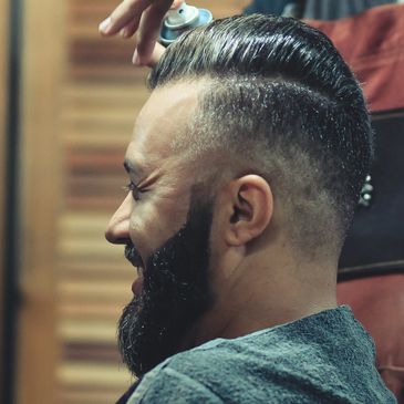 A Man Doing a Haircut to a Man in a Chair